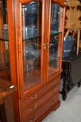 A modern cherry style display cabinet having three drawer base, width approx. 84cm