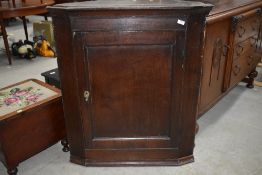 A period oak corner cupboard