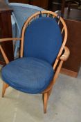 A vintage Ercol low carver chair having typical hoop and stick back design