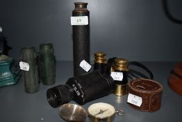 A selection of vintage binoculars, telescope, compass and similar.