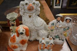 A selection of Staffordshire flat back figures including dogs money box and figure pair