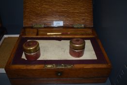 A small late 19th/early 20th century oak folding compartmental box, having section to rear for