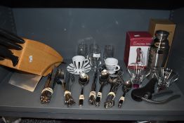 A large selection of cutlery and kitchenalia,cocktail shaker and knife block included.