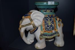 A plant stand in the form of an elephant.