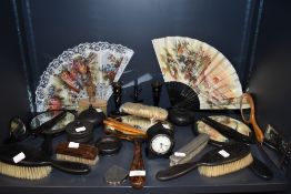 An assortment of dressing table mirrors, fans, glove stretchers,hallmarked brush, candle stick