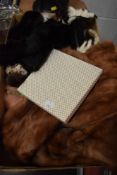 A box of vintage fur and other accessories including mink stole, gloves and more.