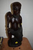 A large hand carved figure of an exotic hunter possibly Indonesian standing