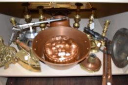 A selection of fire side stove and cooking items including large copper jelly mold candle sticks and