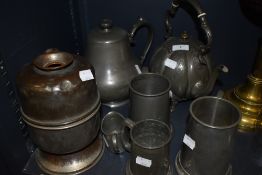 A selection of plated wares and pewter among which are a decorative teapot with embossed design