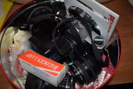 A K1000 Pentax camera and a variety of lenses.