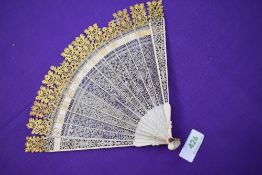 An ivory Brise fan circa 18th century with very fine pierced blades,with carved tips and gilt