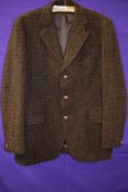 A vintage Harris tweed jacket in brown tones around late 60s/70s, pocket to sides and one to