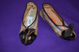 A pair of vintage children's slippers or shoes having oriental styling and rabbit faces to toes in