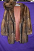 A vintage mink jacket with matching hat,around 1960s in a shorter length,medium size approx.