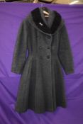 A ladies early 1950s fit and flare coat in grey wool with astrakhan collar,faux double breasted