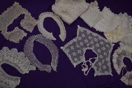 An assortment of early 20th century tray cloths and intricate collars, some crotchet, tatting and