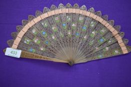 A pierced horn brise fan having hand painted flowers and barrel rivet,circa 1815.