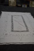 A large antique cut work lace and linen table cloth.