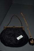 A late 19th/early 20th century black velvet bag having gold tone frame and clasp,alongside a jet