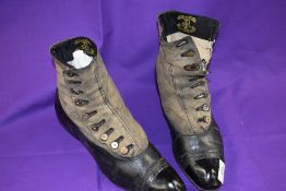 A pair of Edwardian black leather and grey suede boots having mother of pearl buttons to sides and