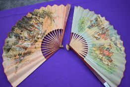 Two large paper fans, one having classical scene and gilt detailing to wooden ribs, the second