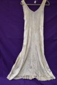 A 1920s full length champagne velvet dress,minor underarm disolouration.small to medium size.