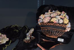 A hand painted set comprising of black and pink satin tea cosy, runner and needle case, around