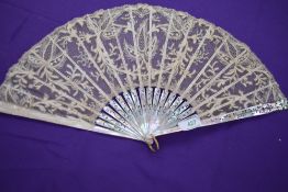 A lace fan, around 1870/80 with mother of pearl ribs with gilt floral detailing.