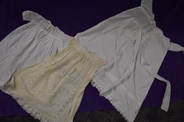 Three antique items of baby clothing including one long gown with cut work and embroidered hem,