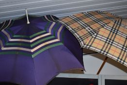 A vintage purple umbrella, around 1940s with pearlescent plastic handle and the other bearing