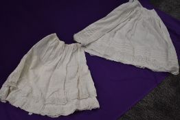 Two late 19th/early 20th century petticoats with cutwork and pin tucks used through both.