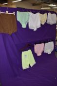 A selection of 1950s and 60s colourful nylon knickers, some having tags still attached,includes