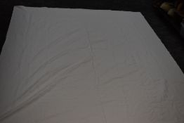 An antique white Marseille bed throw, tightly woven, having raised floral motifs and patterns.