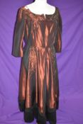 A vintage 1940s full length red evening dress trimmed with black towards the hem, with extensive