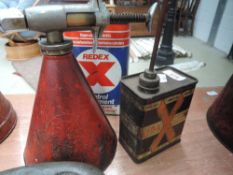 A Redex dispenser and two Redex cans.