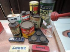A selection of garage advertising tins car polish and Duckhams Nol oil
