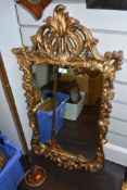An ornate Chippendale style mirror