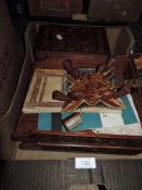 An antique inlaid wooden box with key, two carved oak desk top stacking shelves and a shuttle,