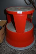 a red painted rolling step set