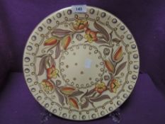 A Charlotte Rhead for Bursley Ware charger having tube lined design of tulips and leaves in