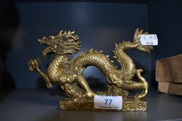 A brass cast Chinese dragon figure measuring approx 20cm long