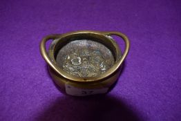 A bronze Chinese incense bowl having six character mark to underside and embossed depiction of scene