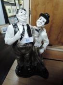 A Laurel and Hardy figurine.
