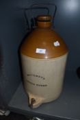 A large earthen ware flagon by Whiteway's Devon Cyder with tap and lid to top