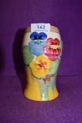 A Clarice Cliff bizarre vase having pansy design on cream and yellow ground.