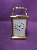 A French carriage clock having bevelled glass panels to all sides and Roman numerals to face.