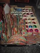 A box full of vintage Christmas decorations, including baubles and and paper decorations.