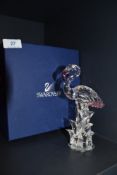 A glass figurine of a flamingo by Swarovski in box