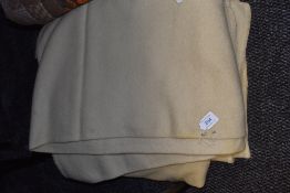 Two cream colour wool blankets possibly one with faded utility mark.