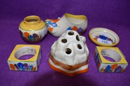 A collection of Clarice Cliff Bizarre including crocus napkin rings, vases, dish and clog.